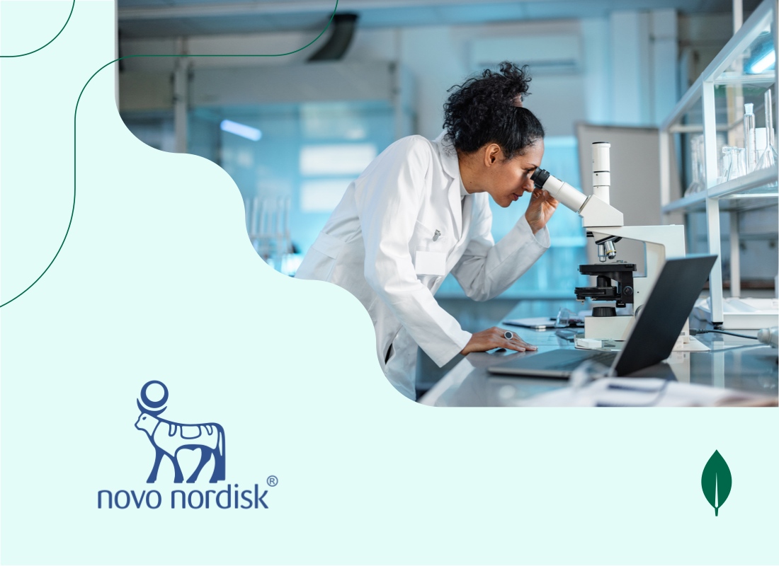 Woman in a lab coat observing a microscope in a professional laboratory setting.