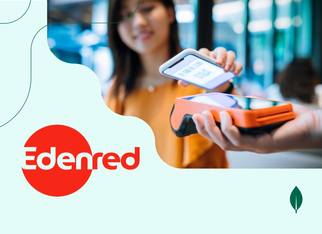 A young woman holding her phone and making a payment by scanning a QR code on a swipe machine.