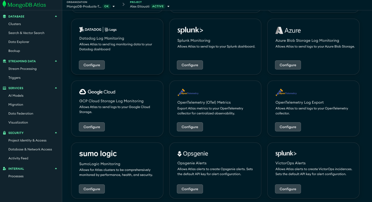Screenshot of the MongoDB Atlas Project Integrations dashboard, displaying a grid of configuration cards for various third-party observability tools, including Datadog, Splunk, Azure Blob Storage, Google Cloud Storage, OpenTelemetry (OTel) Metrics, and Opsgenie, each with a 'Configure' button.