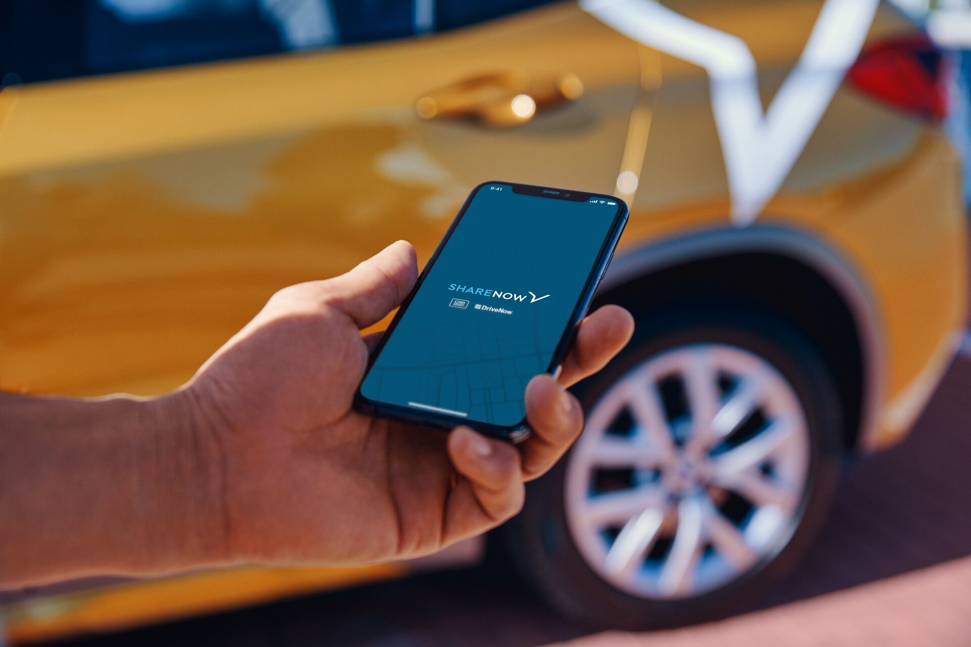 A photo of a smartphone with the SHARENOW app running.