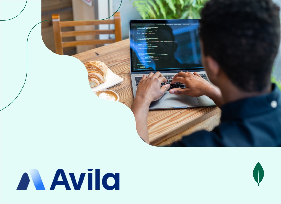 Photo of a man working on a laptop.