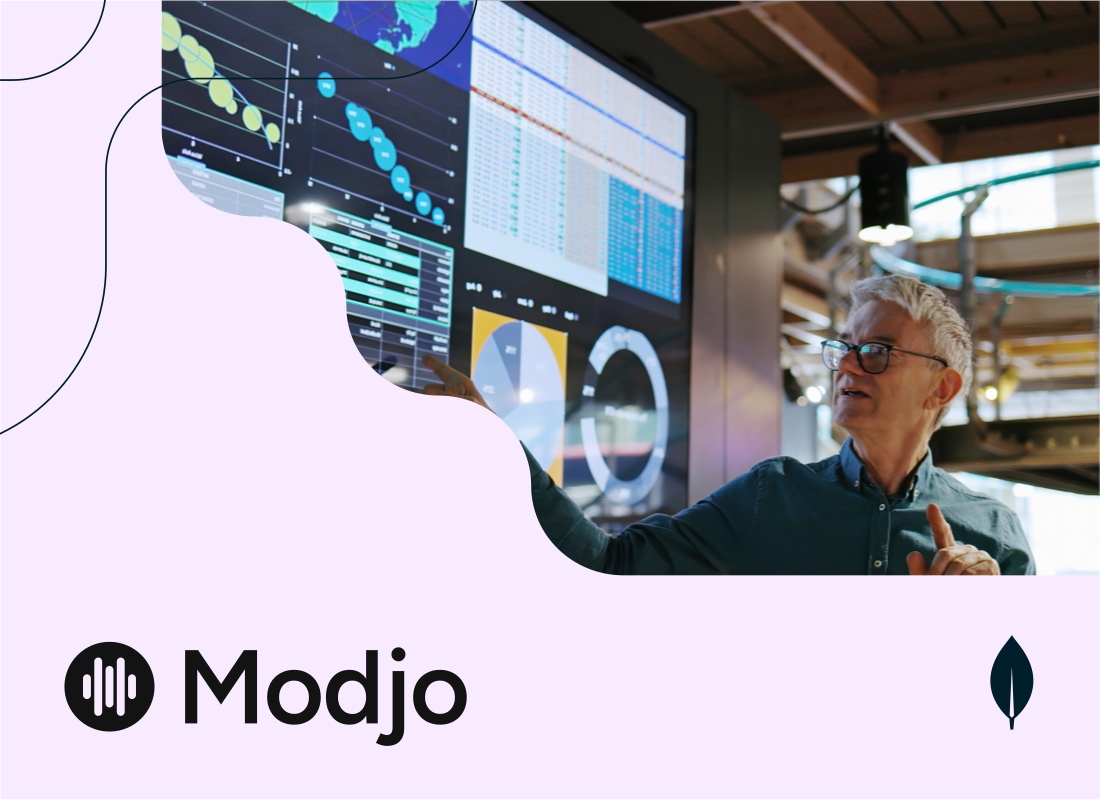 An experienced professional demonstrating a dashboard SaaS application on a large screen.