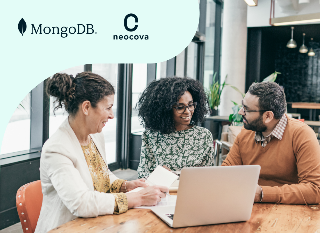 A group of professionals having a discussion in front of a laptop