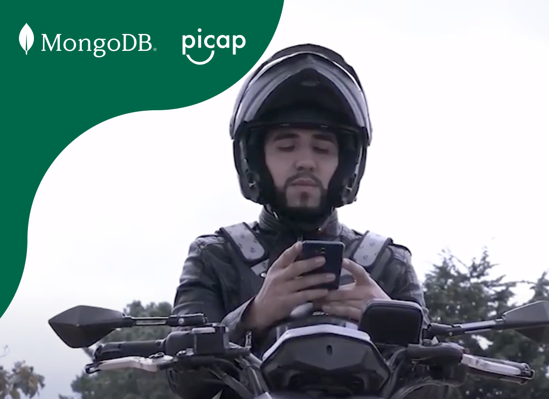 A man sitting on a motorcycle while using his phone for navigation.