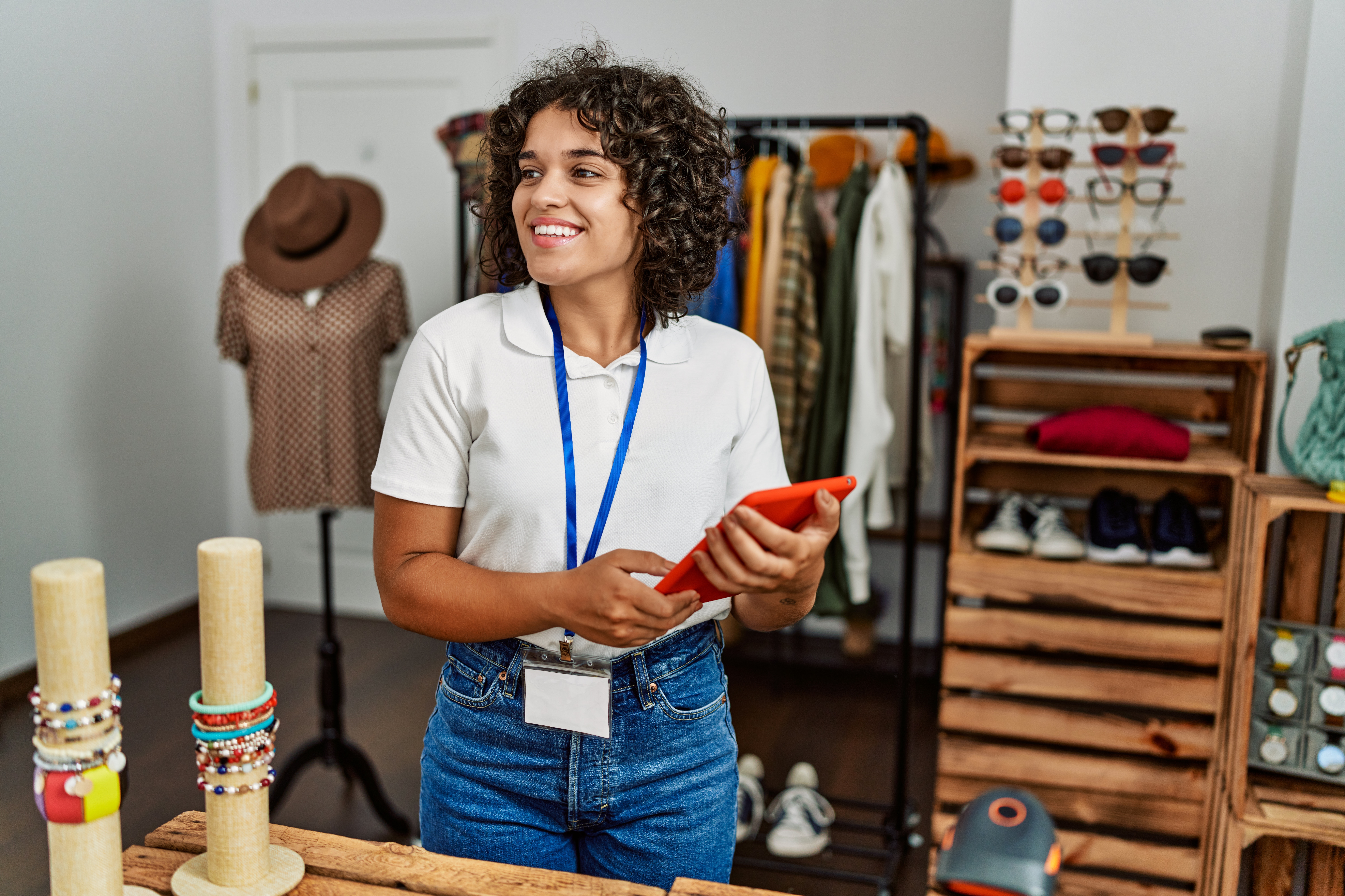 A shopkeeper using touchpad working at clothing store