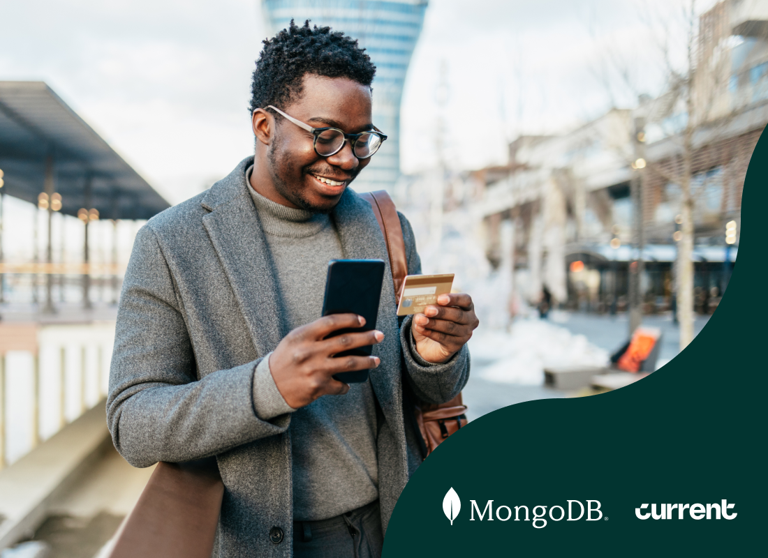 Person smiling while holding a mobile phone and a credit card.