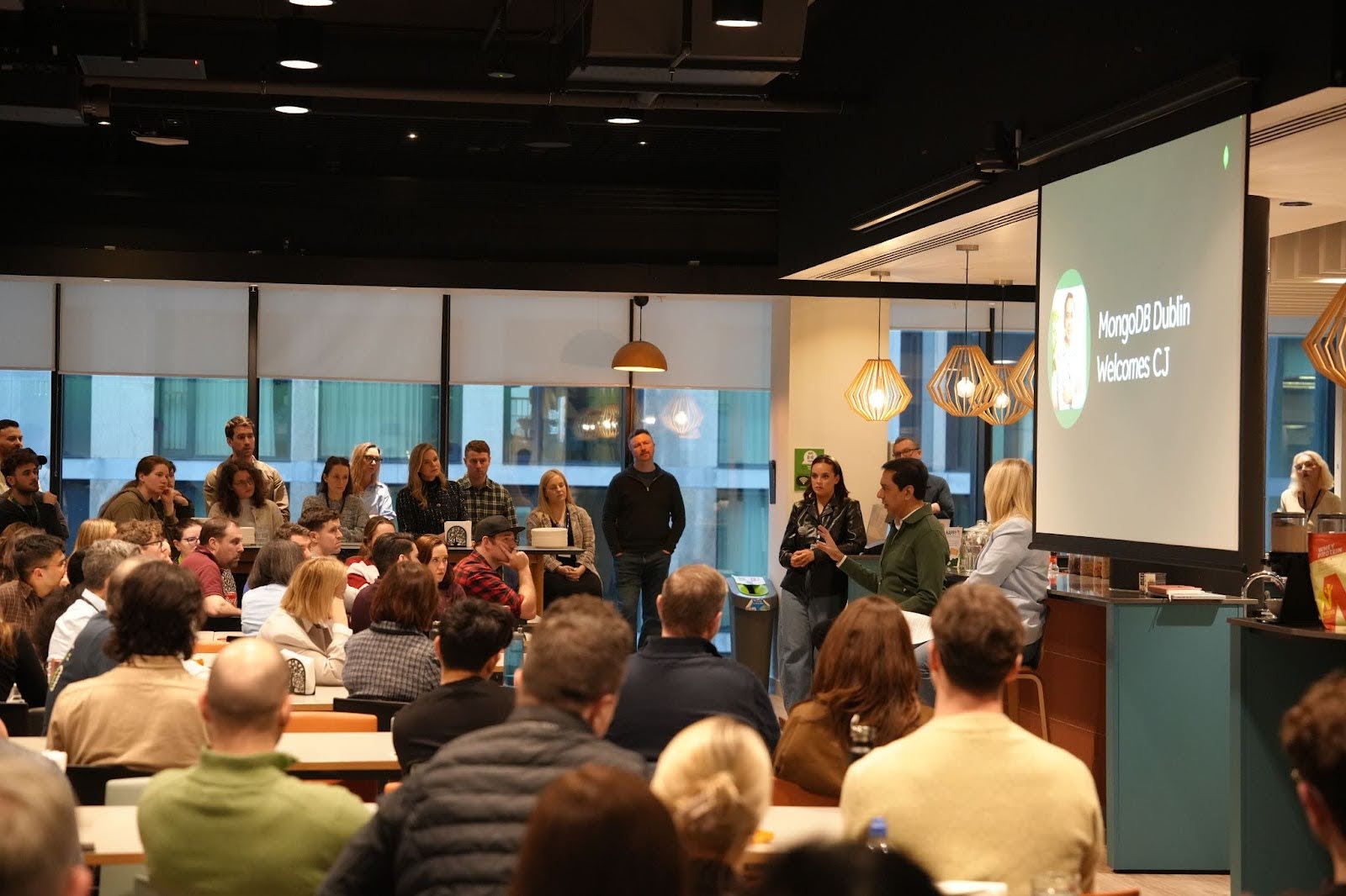 Image of CEO, CJ Desai, speaking in front of a group of employees in the Dublin office.