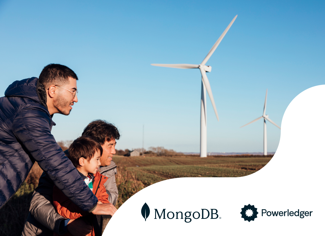 A photo of three people with wind turbines in the background.