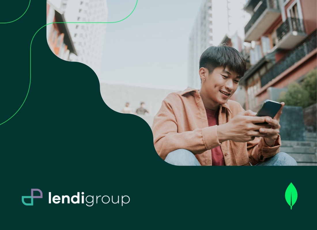 A man is seated on the steps, engaged with his phone