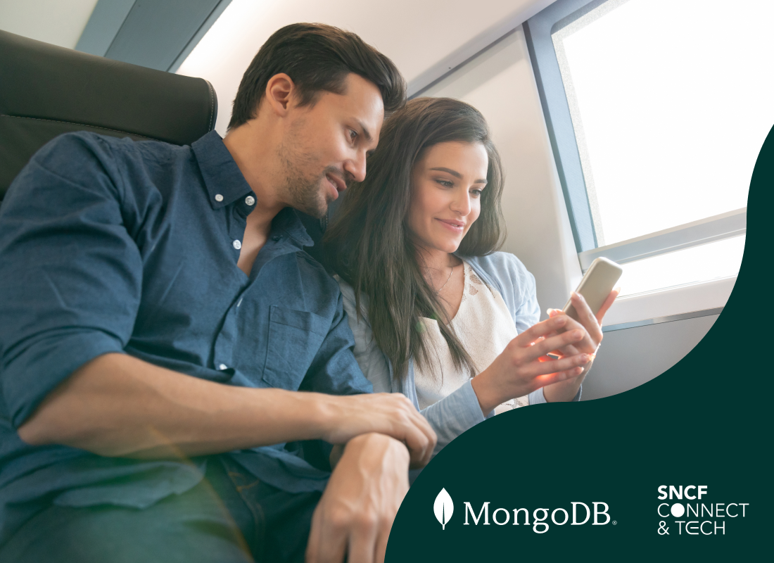 Photo of a man and woman looking at a mobile screen.