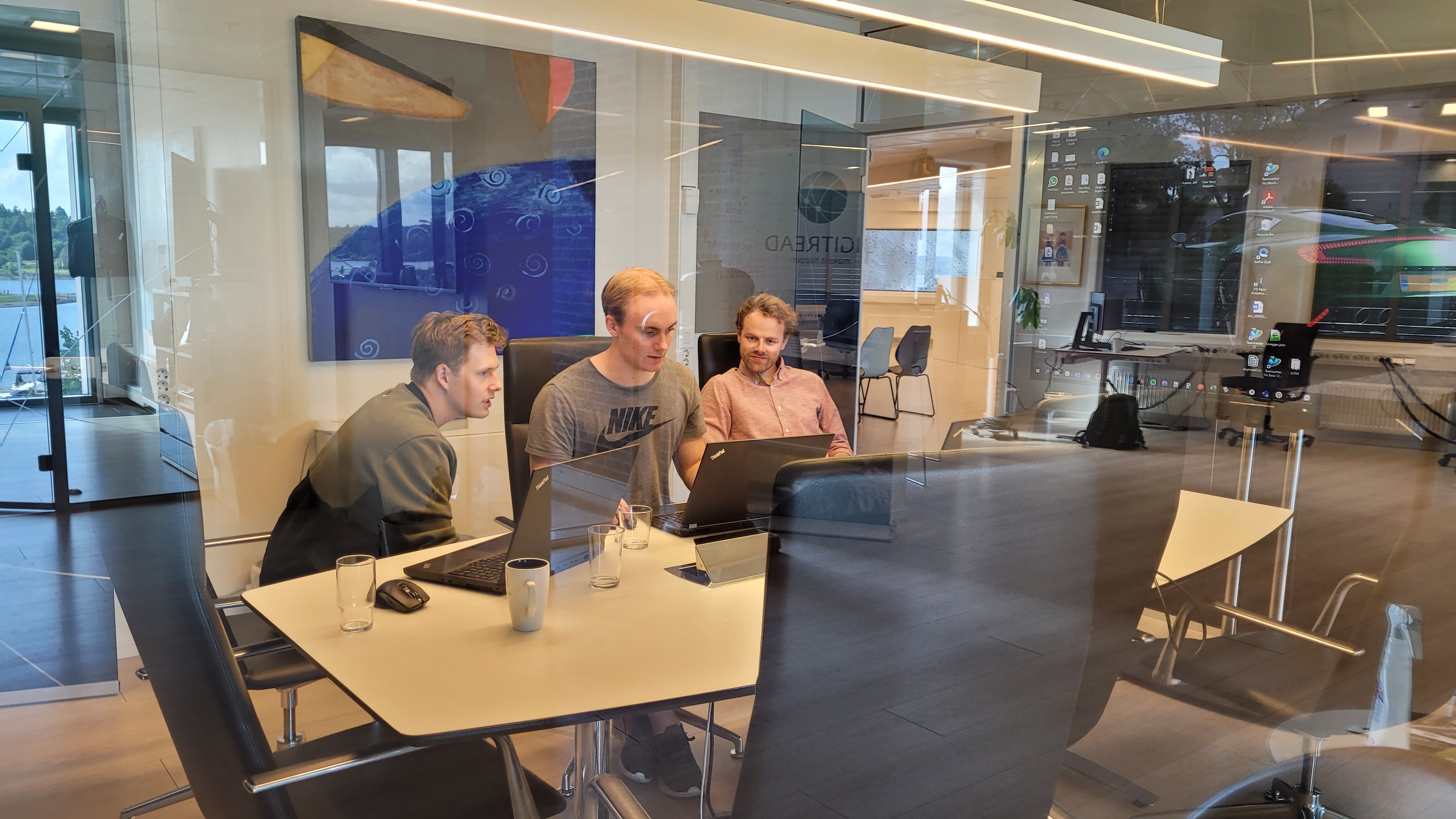 A photo of the company's employees at work in the office.