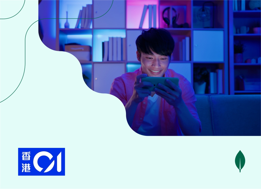 A young person holding and looking at a mobile phone.