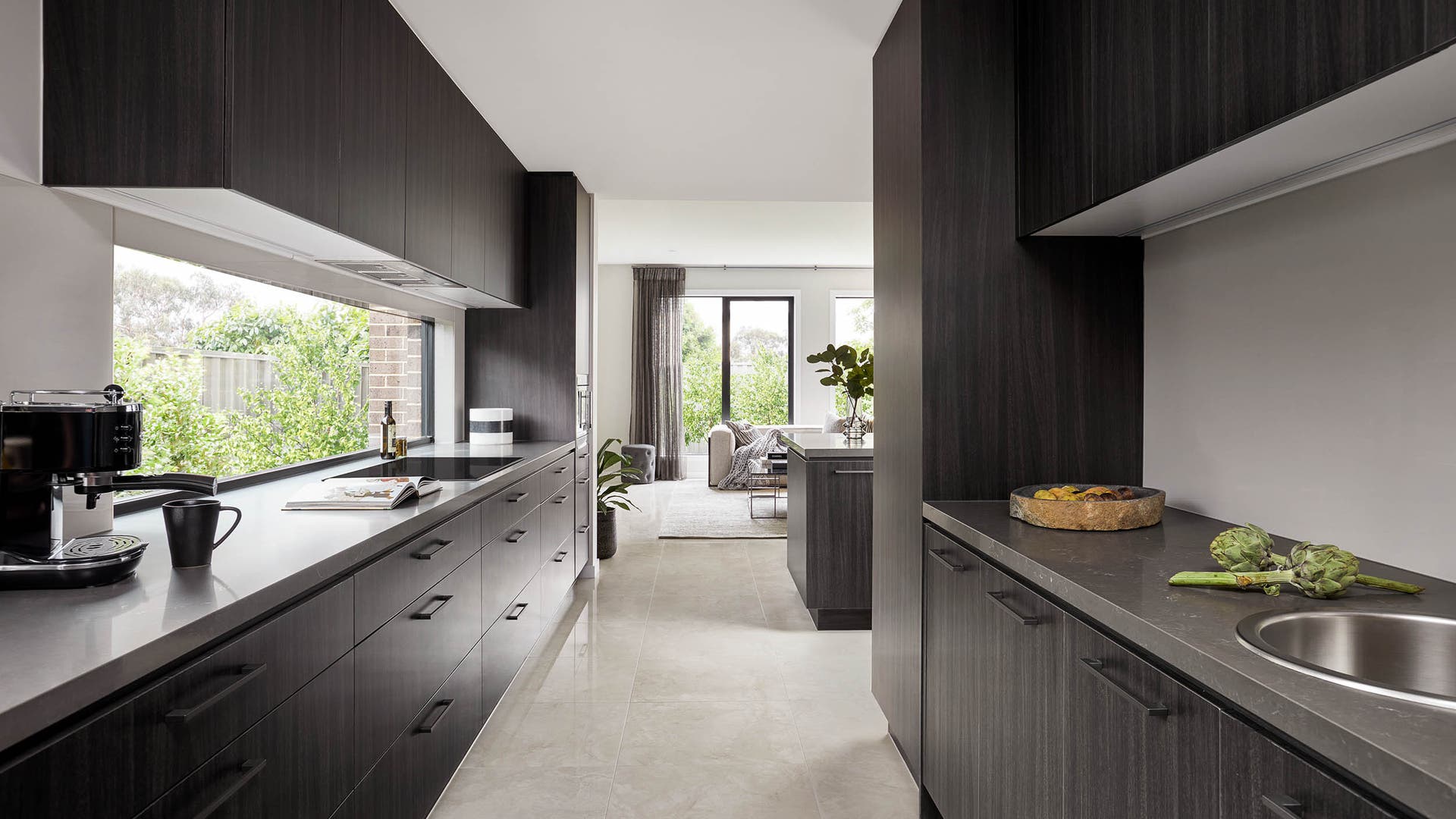 A dark timber and black kitchen design is available from Henley Homes.