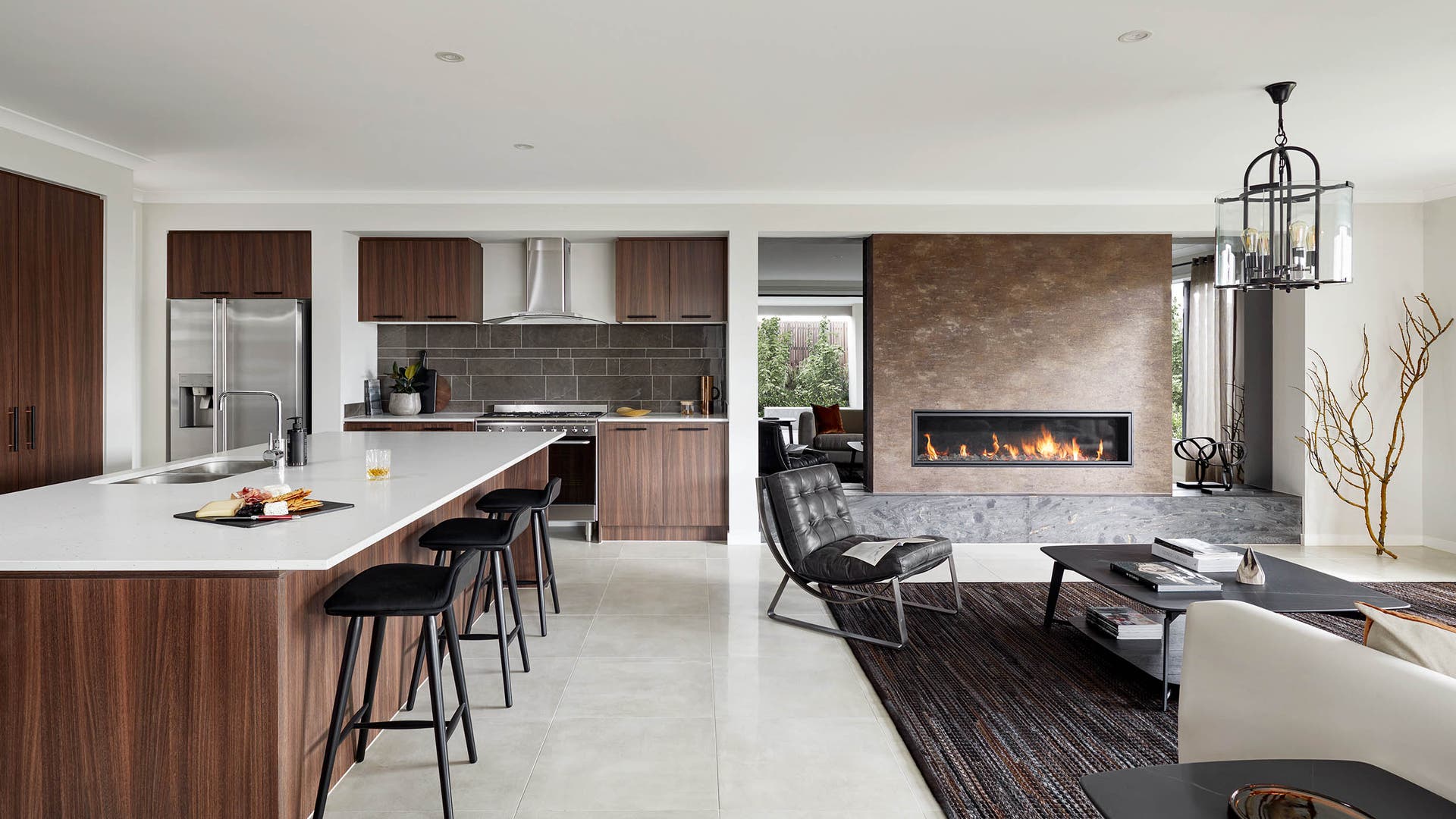 Sahara 40 kitchen, living and dining area featuring a dark and moody colour scheme with a fireplace