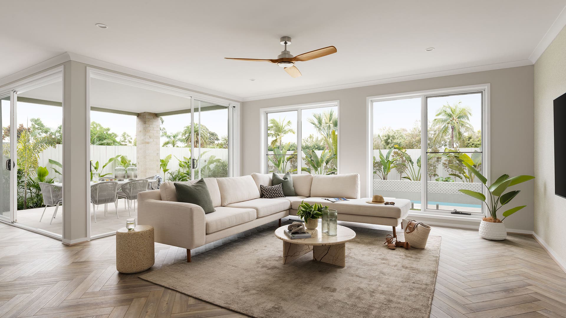 Plantation Homes living room with a spacious, large area and a coastal vibe