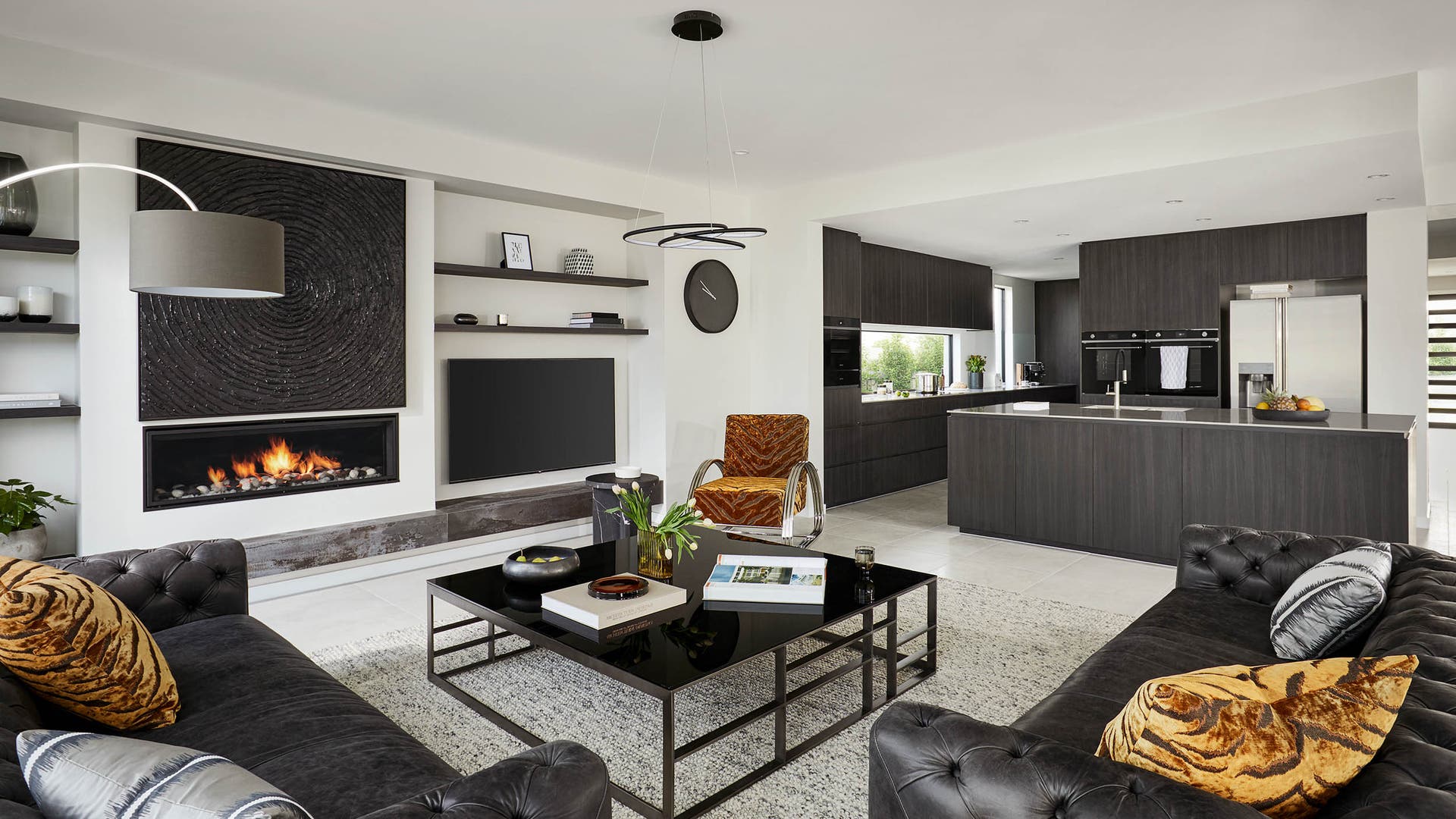 Dark and moody Montessa 43 kitchen area with a window splashback and pops of orange.