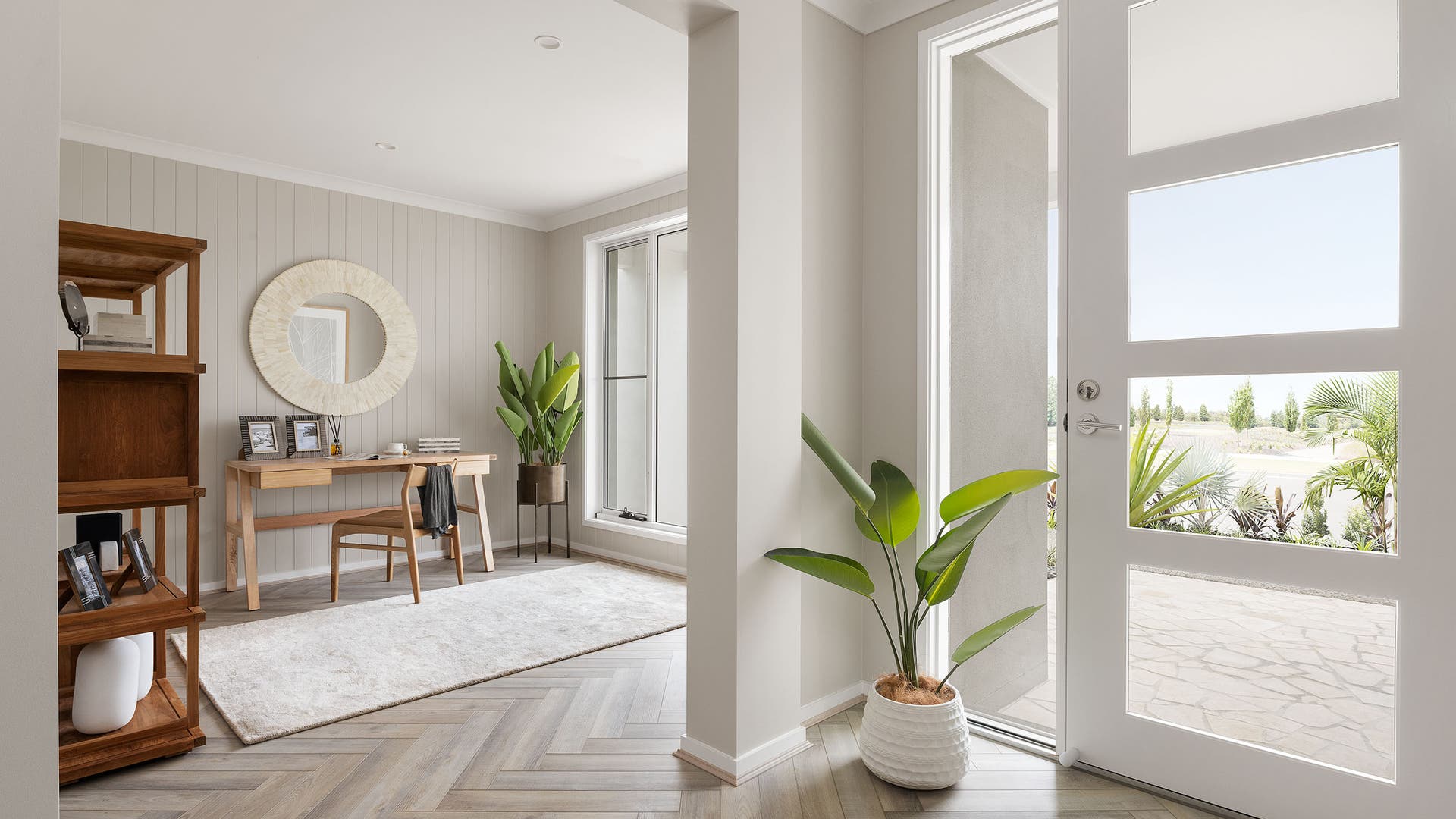 Entry and study area with modern natural-toned walls and wooden flooring.