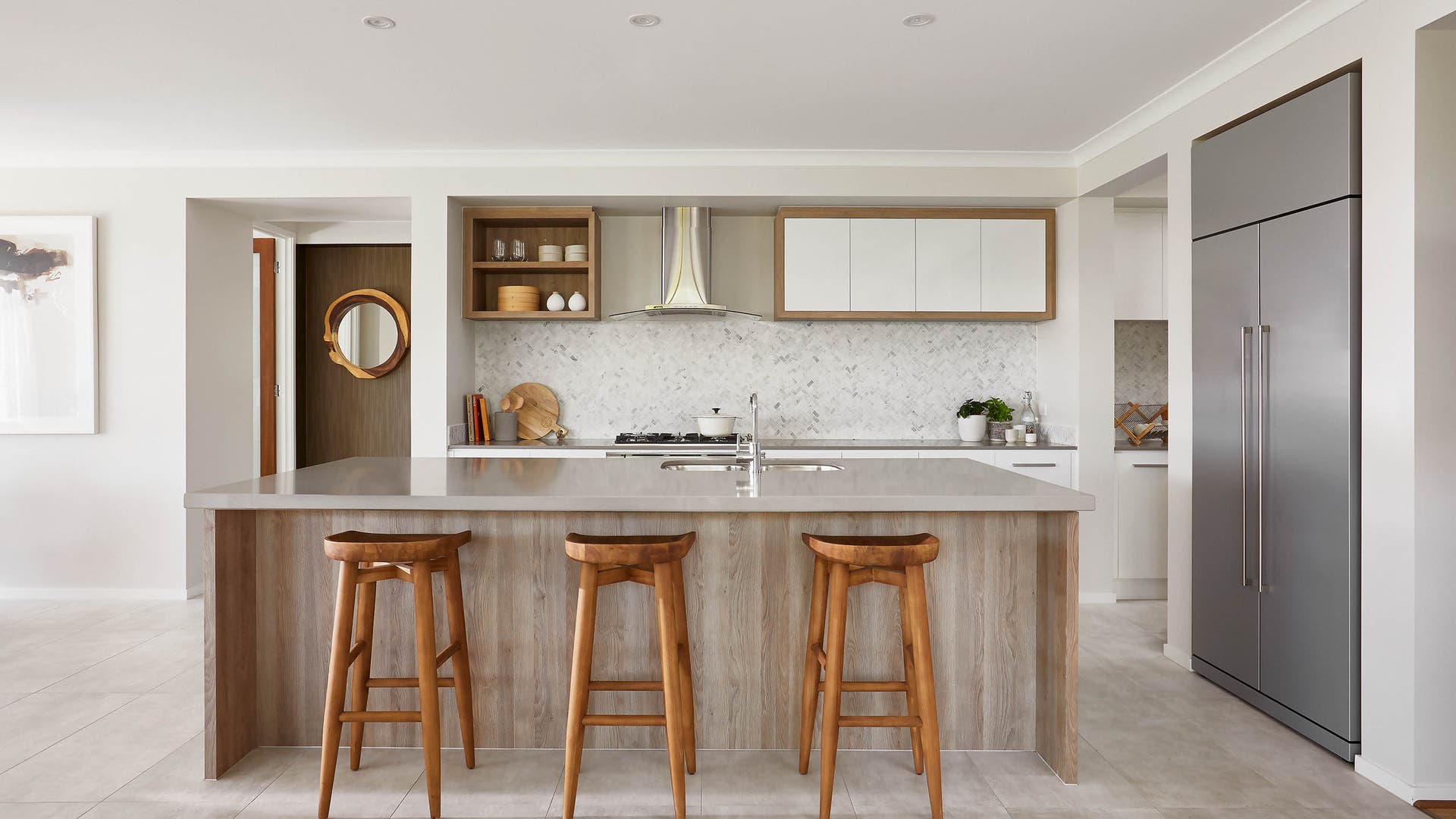 Spacious kitchen area with warm, neutral-coloured walls and timber furniture