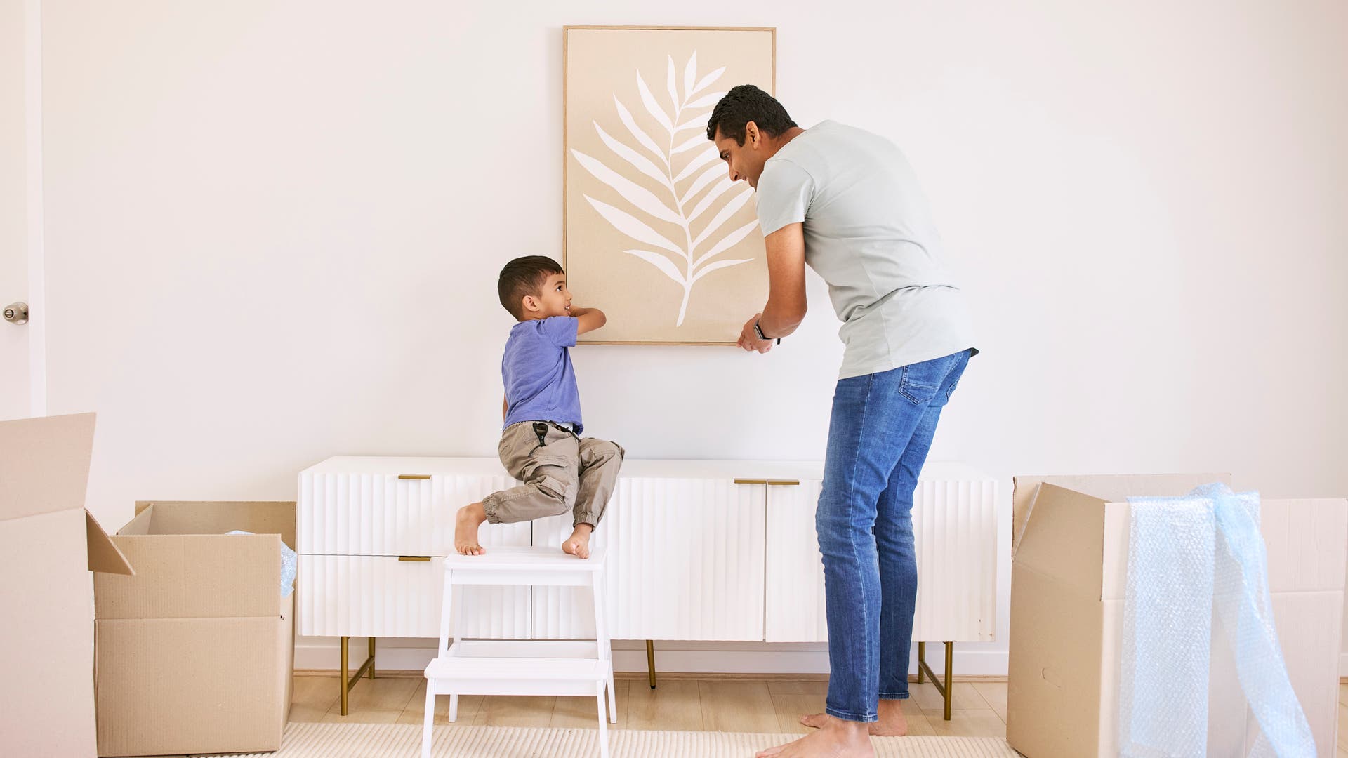 Father and son decorating their new home
