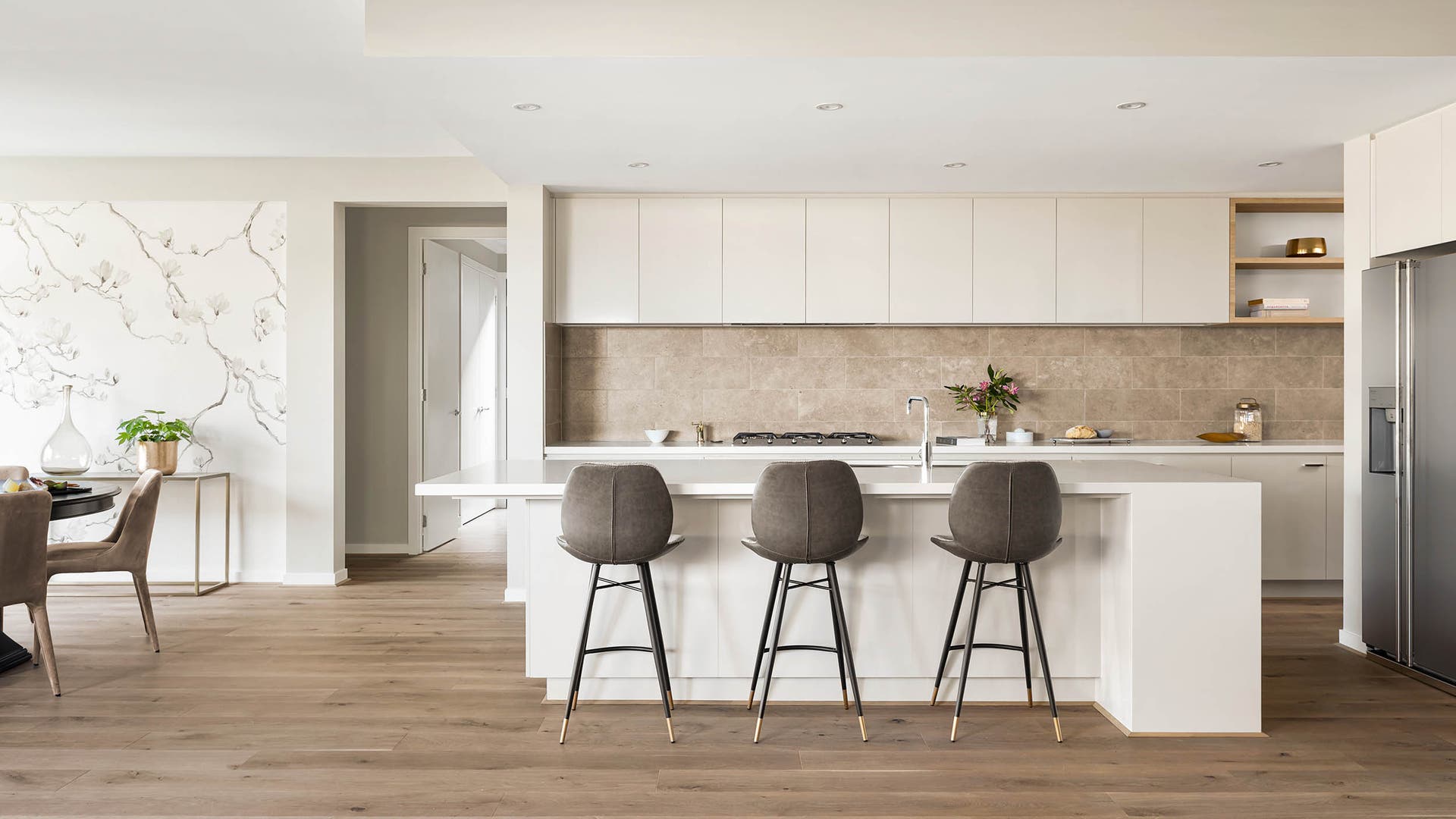 Oversized kitchen in the Amalfi 33A featuring a crisp white colour pallette with pops of light wood and greys.