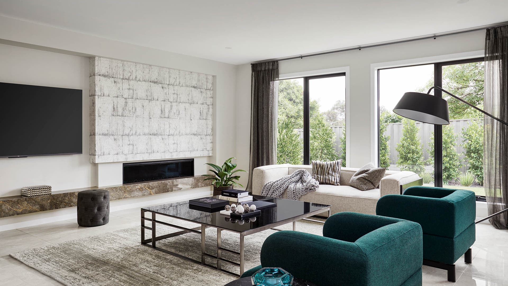Montessa 43 lounge area featuring a netural tone colour pallette with pops of forest green and loads of natural light.