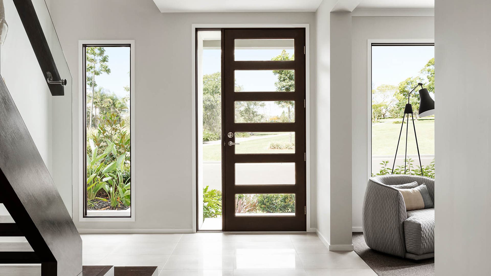 The entryway features an open space area with a floor-to-ceiling window that floods the space with natural light. It seamlessly connects to the study room, creating a welcoming and airy atmosphere.