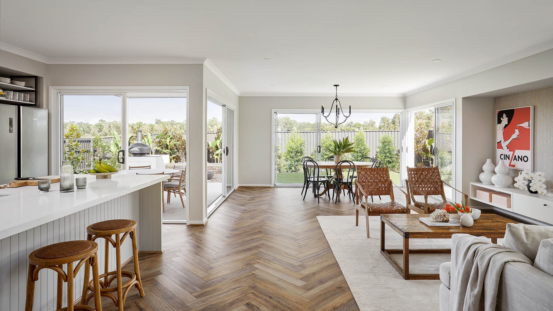 Spacious tropical themed living and dining area with timber warm coloured floor.