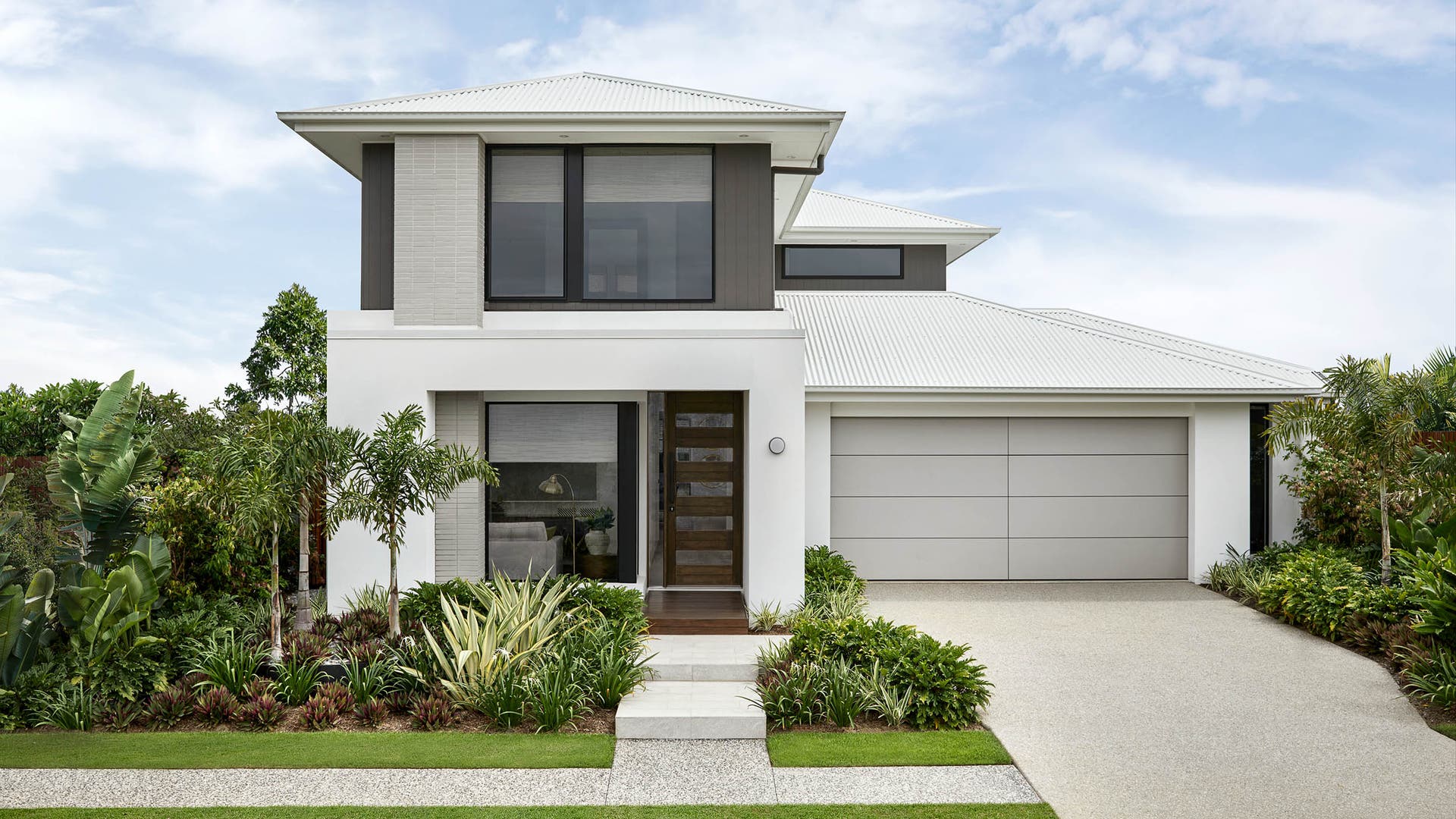 Double storey home with cool white and brown accent coloured facade design