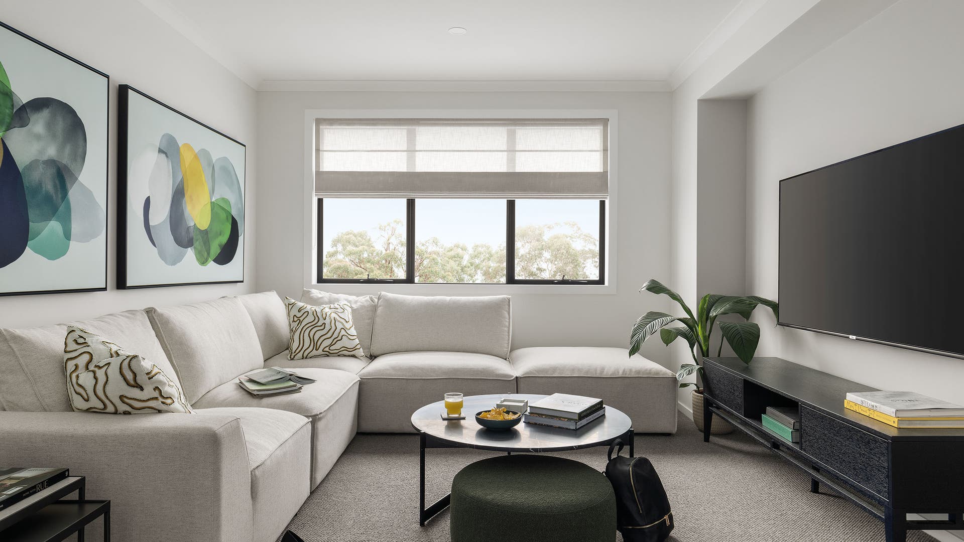 Theatre room featuring light greys with pops of green.