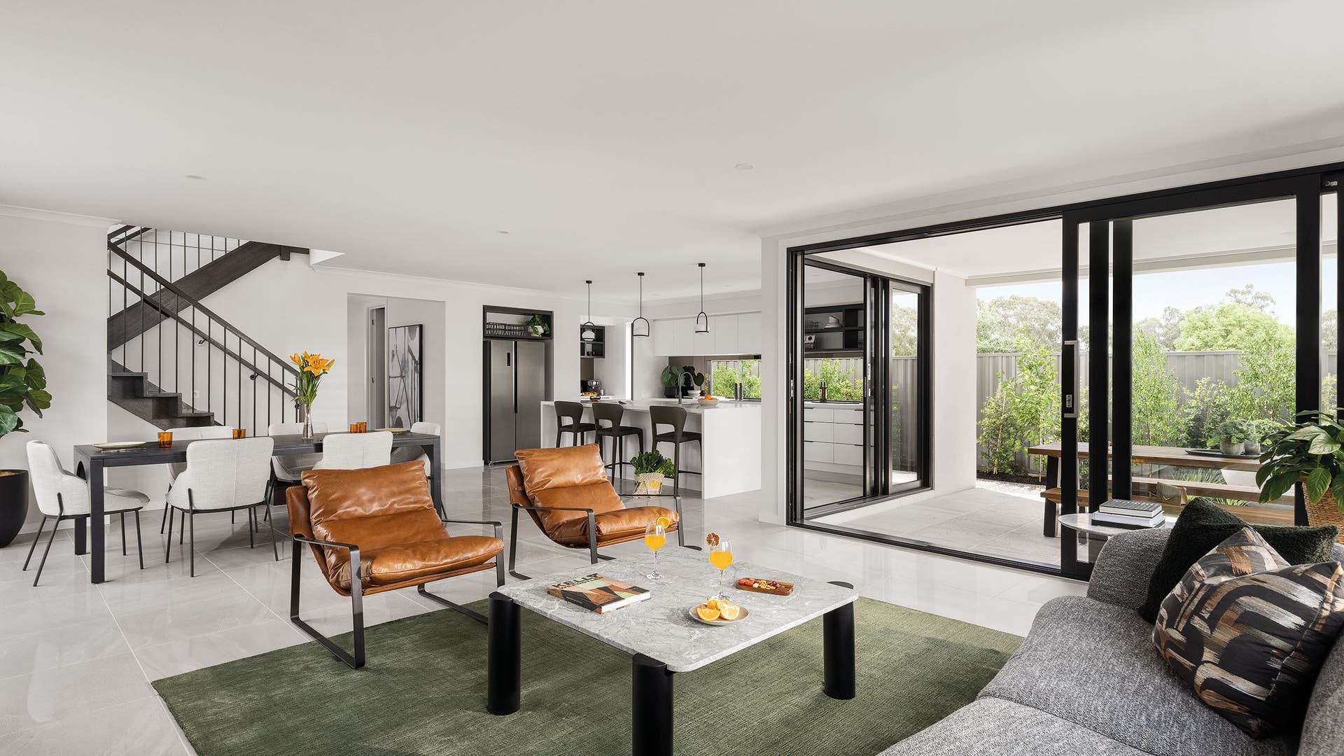 Airlie 41R on display in Kalkallo - Kitchen, living, dining & alfresco area featuring warm bronze hues to sophisticated citruses and pops of light green.