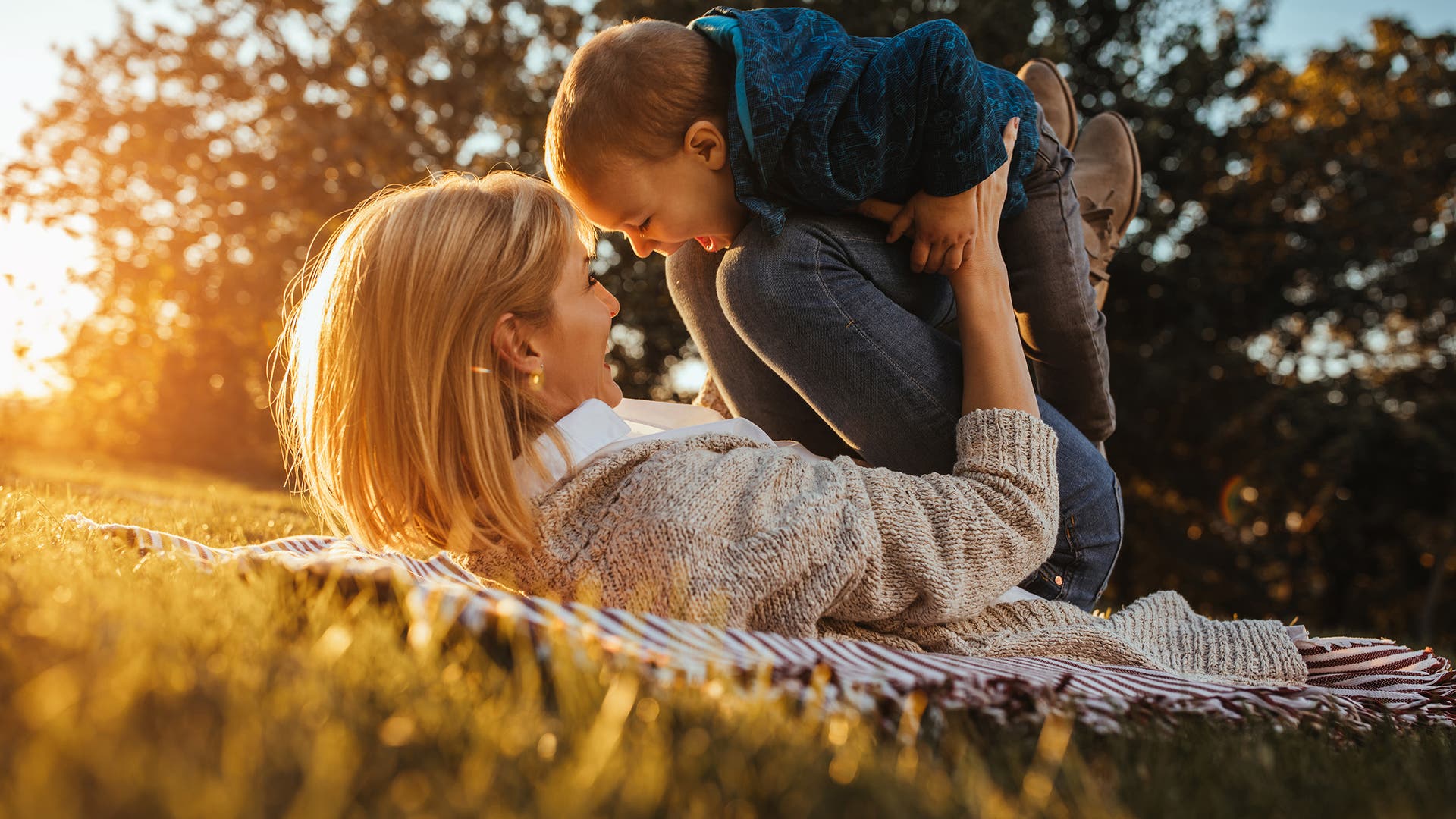 Child & mother playing in a park
