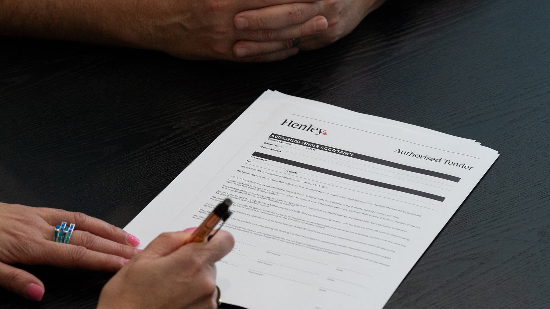 Customers signing Henley tender document