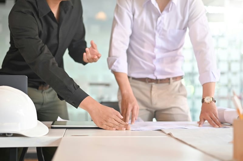 Employees looking at blueprints