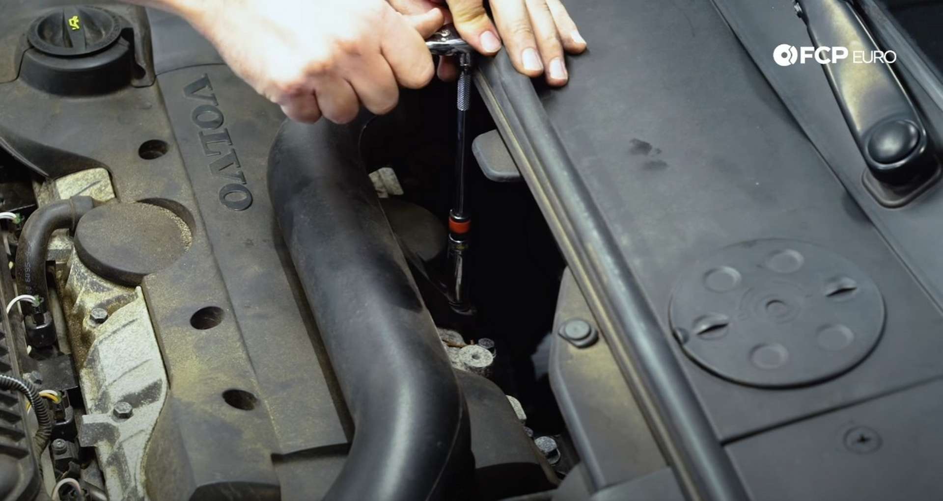 DIY Volvo Spark Plug and Ignition Coil Replacement resecurring the intake tube to the engine