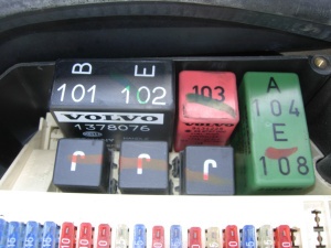 Green headlight relay in a 1998 Volvo S70, remove to install a gray "Follow me home" relay.