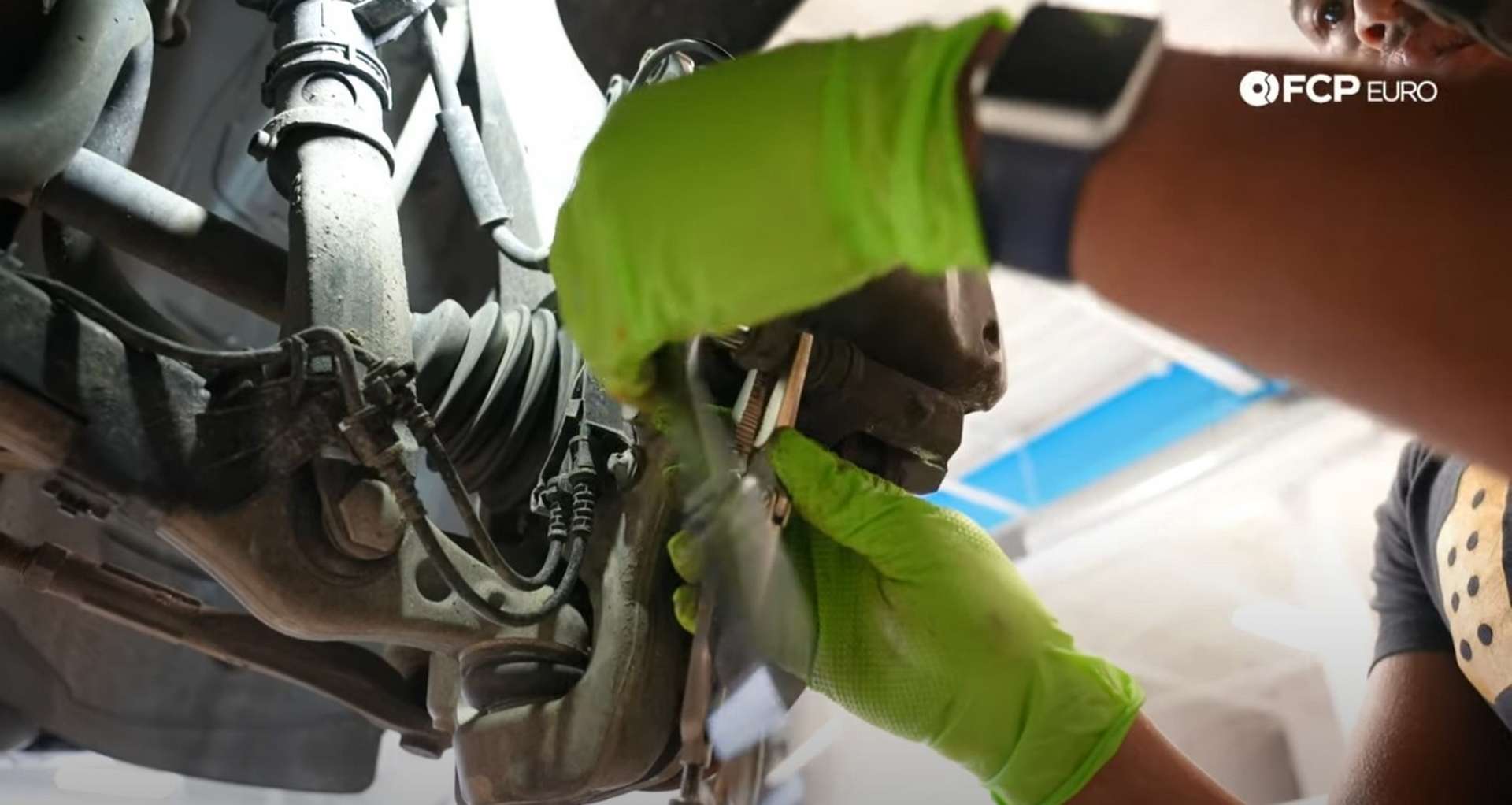 DIY Mercedes-Benz W205 Front Brake Service holding the guide pin nut with the vice grips
