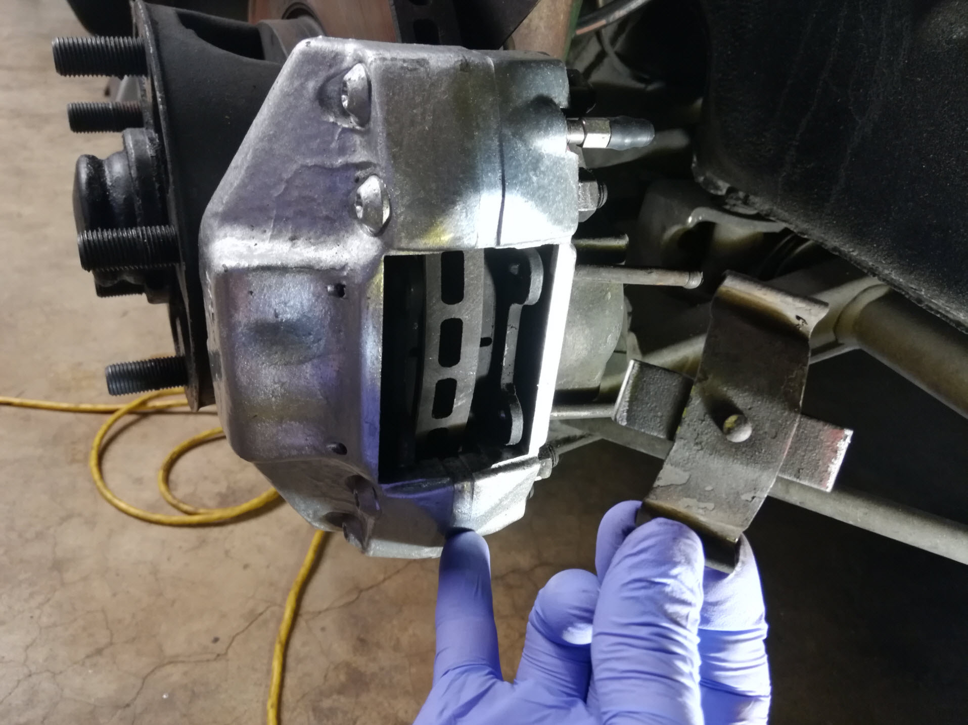 Air-cooled Porsche 911 brake pad retaining spring removal.