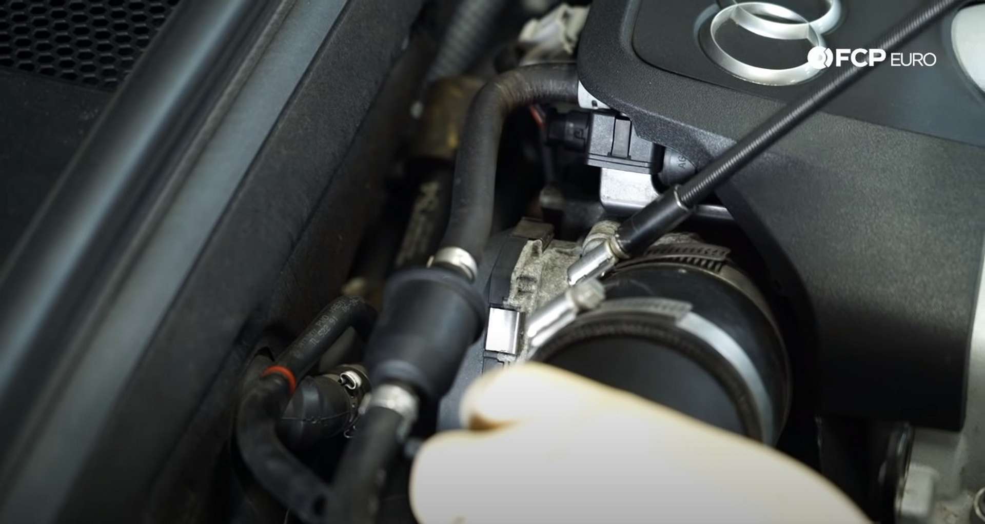 DIY Audi 3.0T Supercharger Oil Change loosening the intake hose clamp