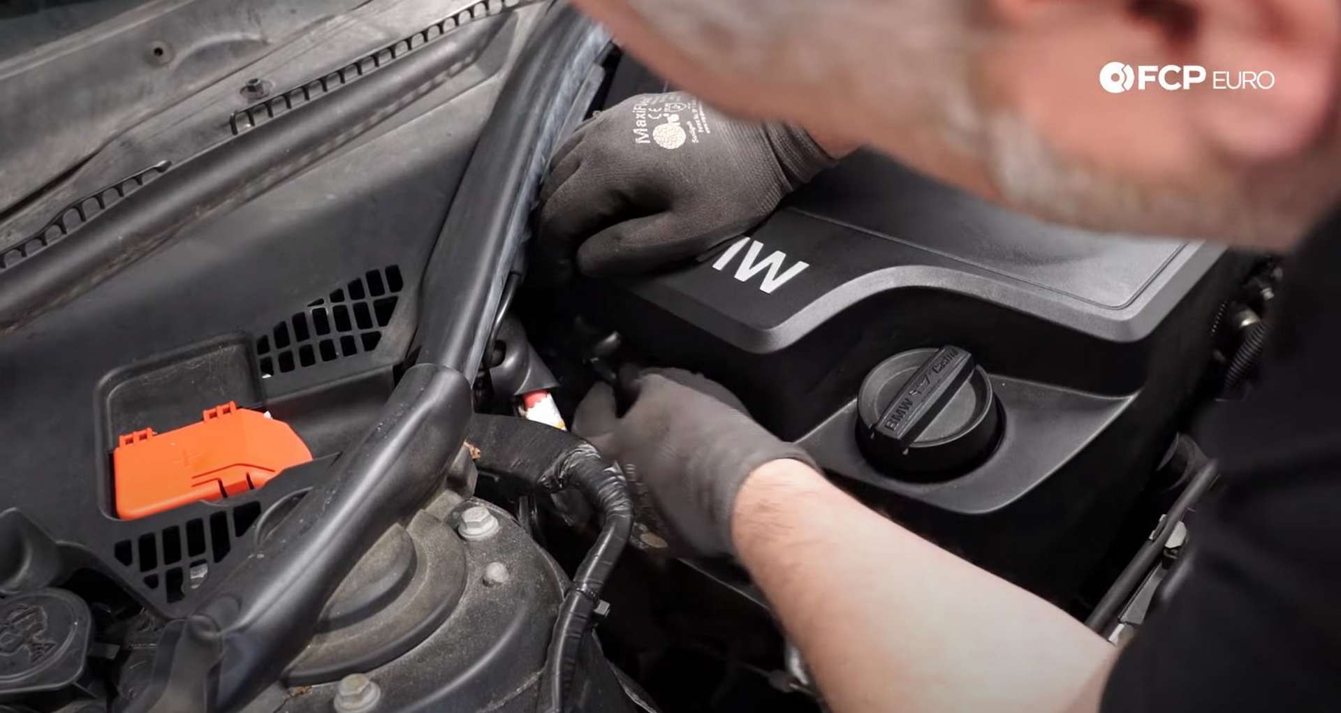 DIY BMW F30 Fuel Injector Replacement removing the vacuum lines from the engine cover