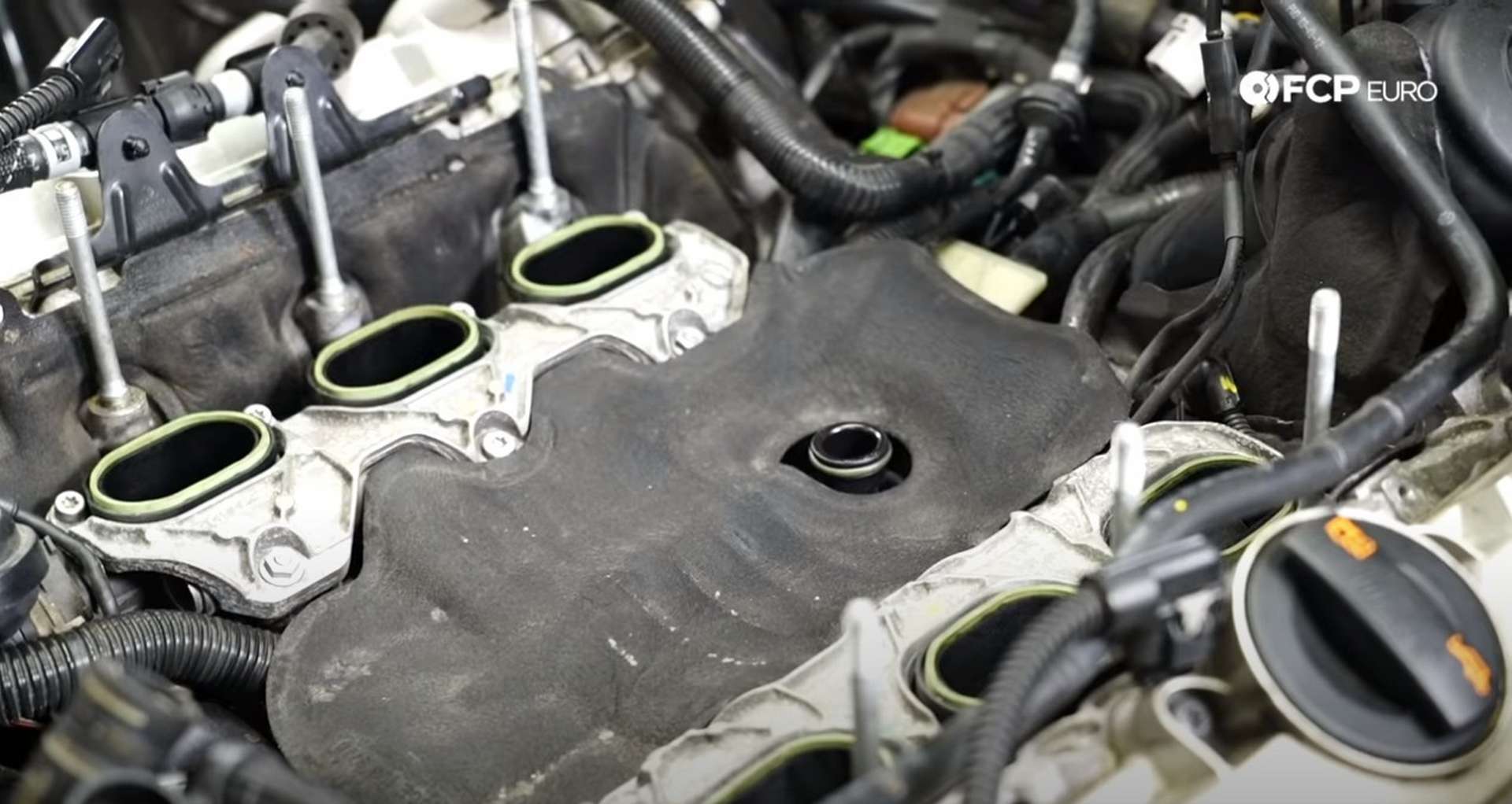 DIY Audi 3.0T Supercharger Oil Change installing the engine valley cover