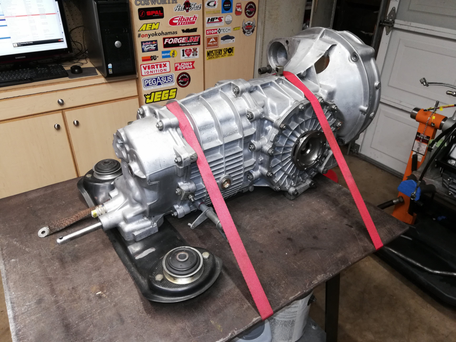 Air-cooled Porsche 911 gearbox on work table.