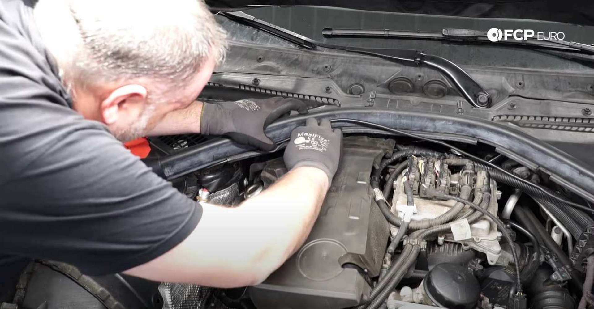 DIY BMW F30 Valve Cover Replacement running the hood cable through the hood seal
