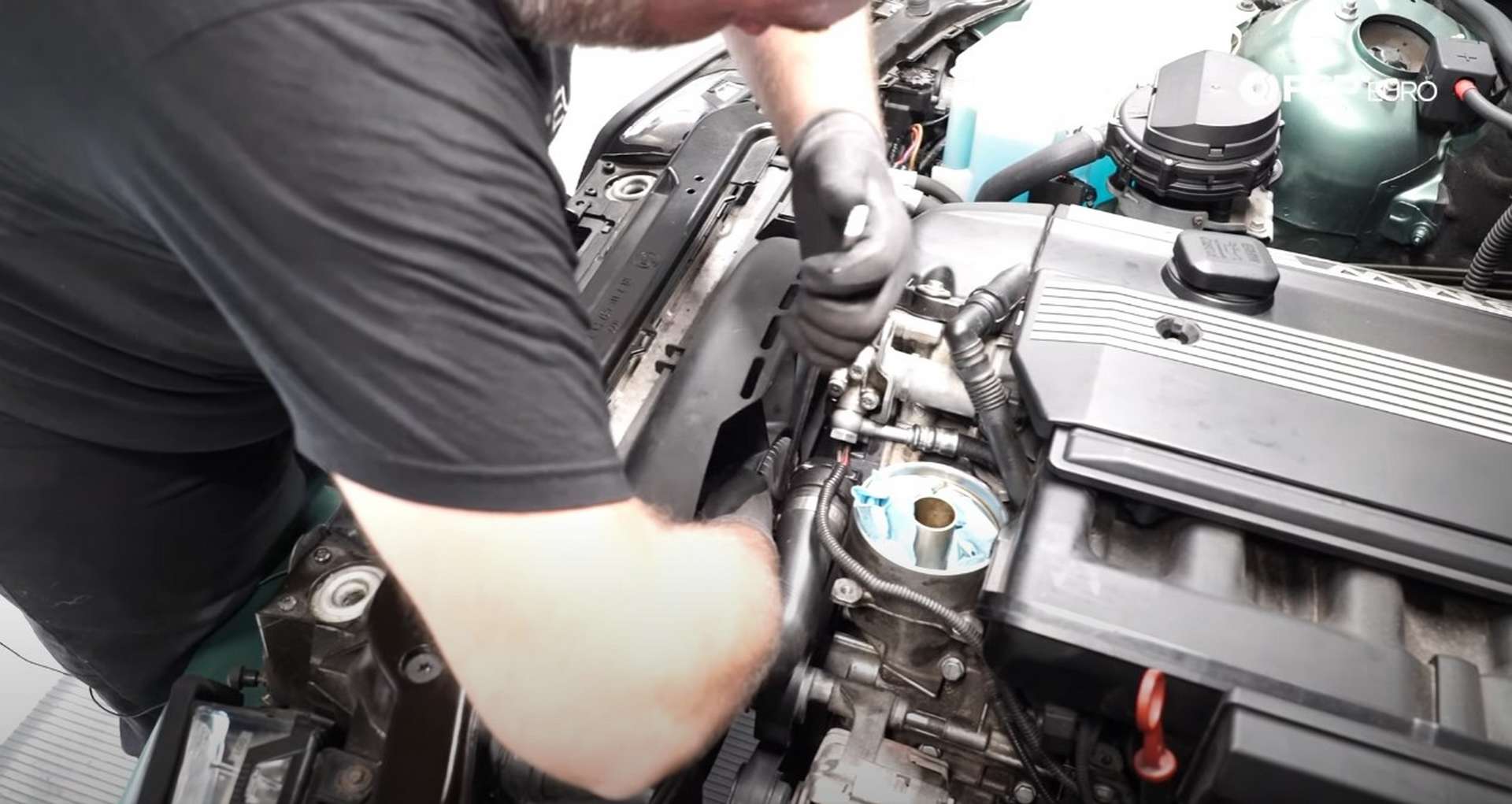 DIY BMW E46 Oil Filter Housing Gasket and VANOS Line Replacement installing the fan assembly
