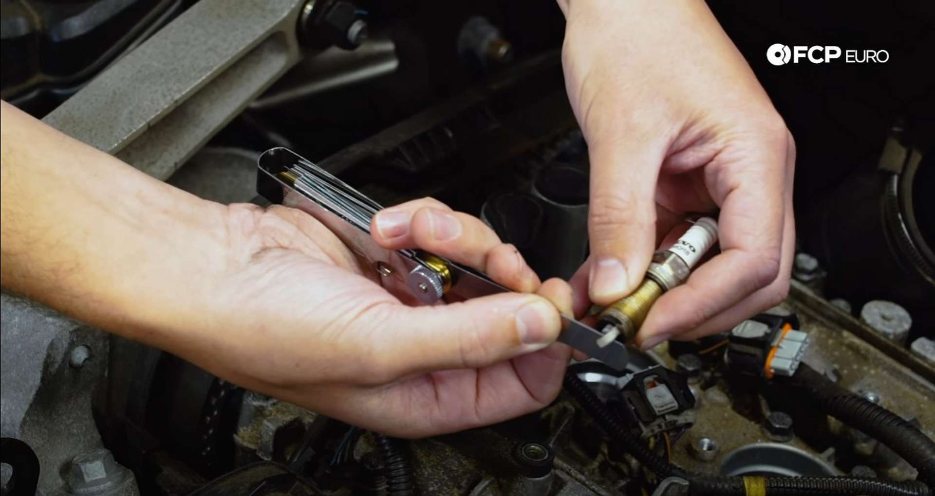 DIY Volvo Spark Plug and Ignition Coil Replacement checking the spark plug gap