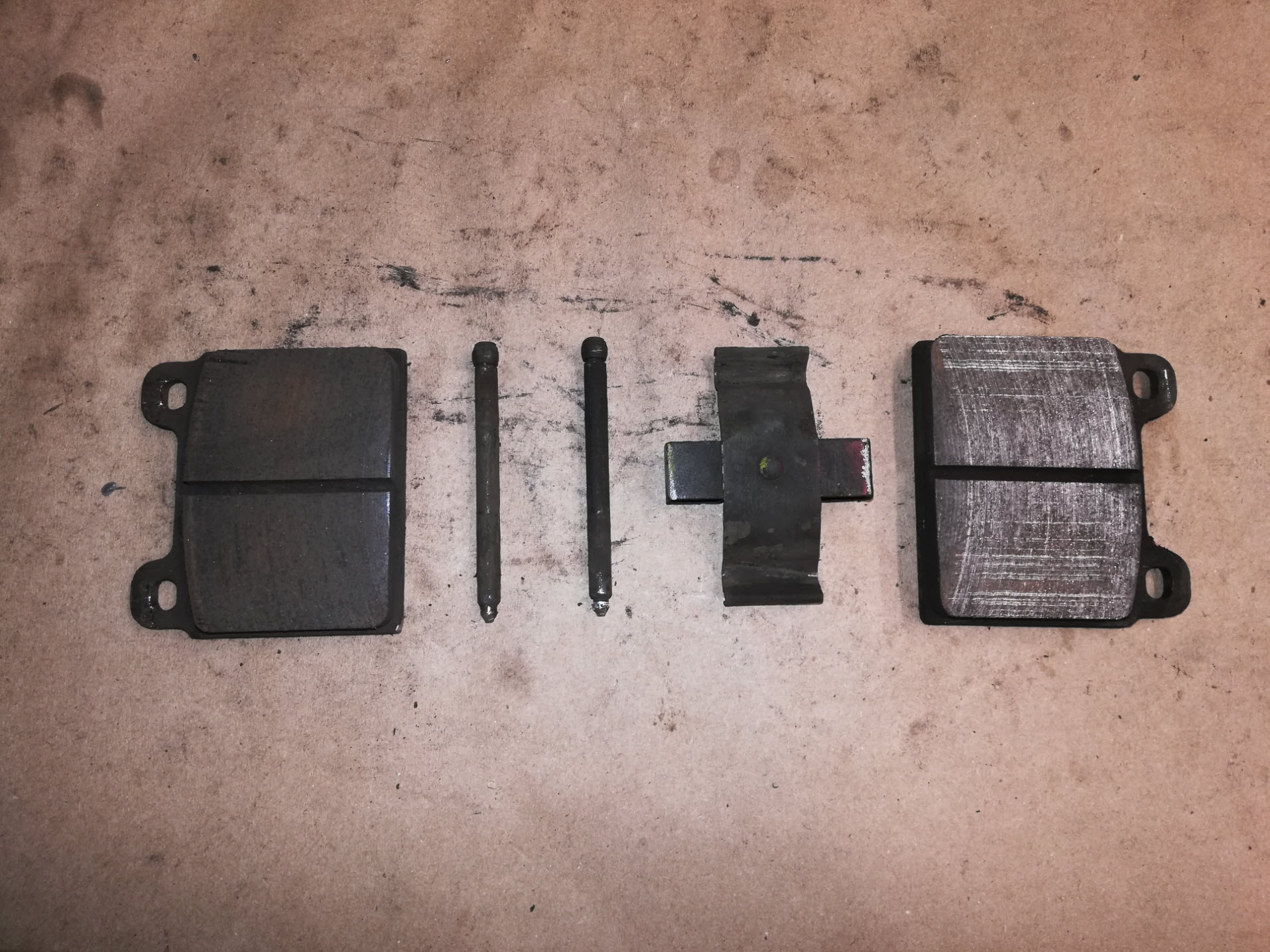 Air-cooled Porsche 911 brake pads and retaining hardware.