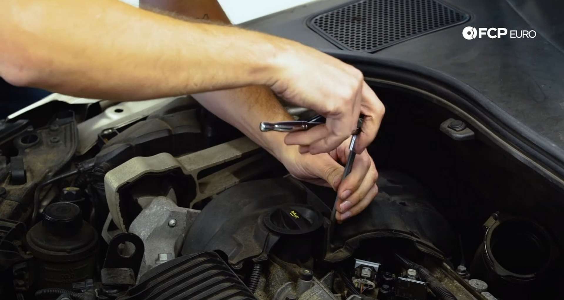DIY Volvo Spark Plug and Ignition Coil Replacement tightening the timing cover fasteners