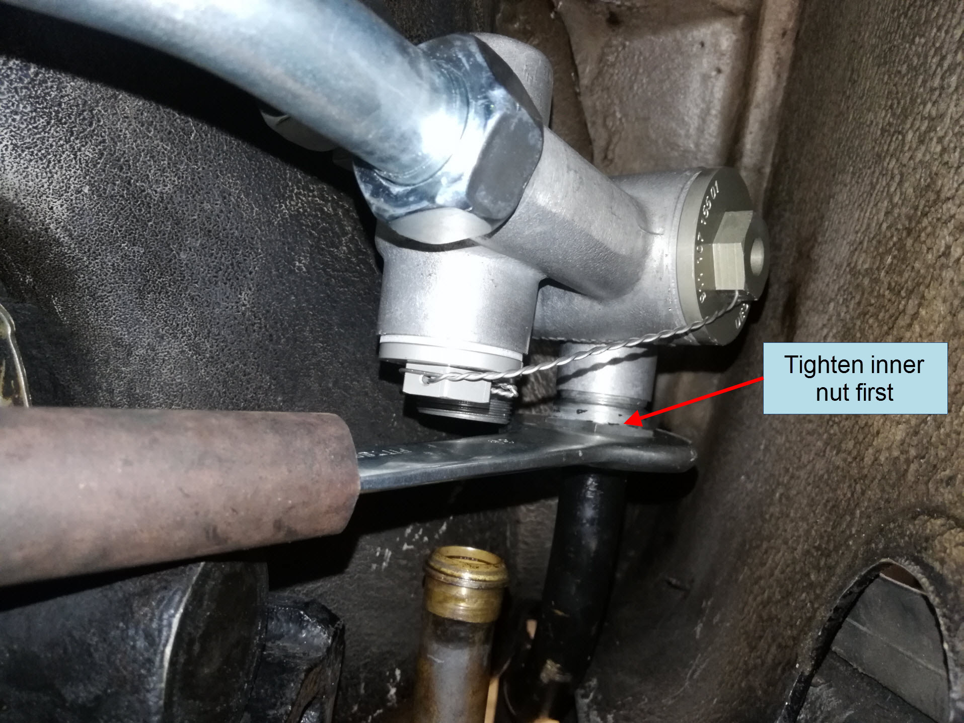 Air-cooled Porsche 911 hard oil cooler line installation on thermostat.