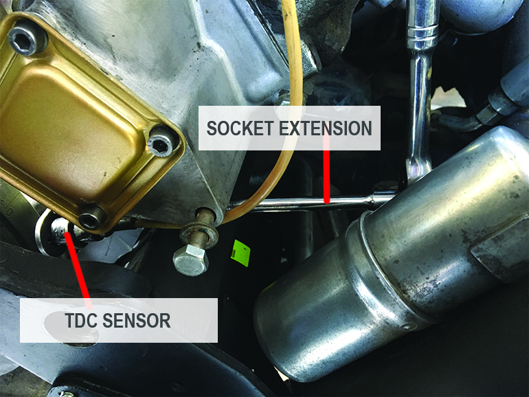 Socket wrench and extension in place to remove TCD sensor
