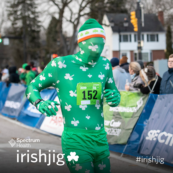 Person running in St. Patrick's Day themed body suit