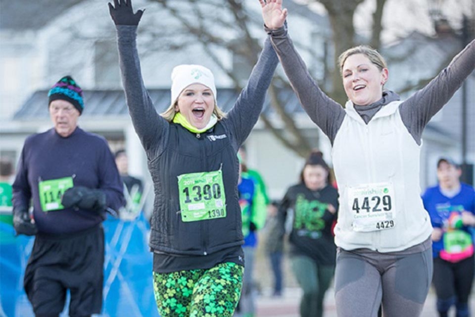 Runners with arms in air